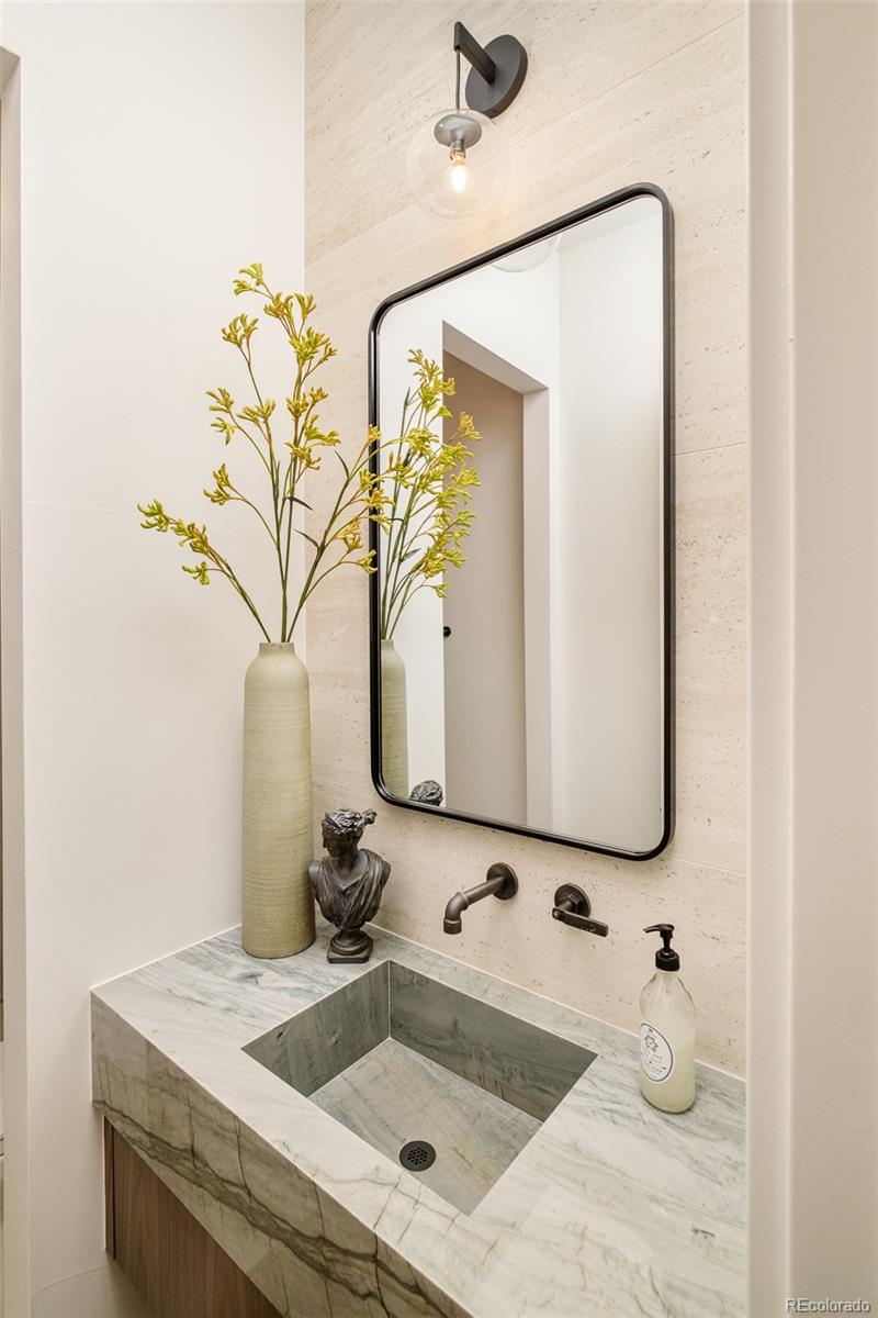 1253 South High Street Denver, CO 80210 - Photo 22 of 46 a bathroom with a sink and a mirror