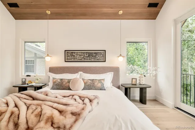 a bedroom with a bed and a large window