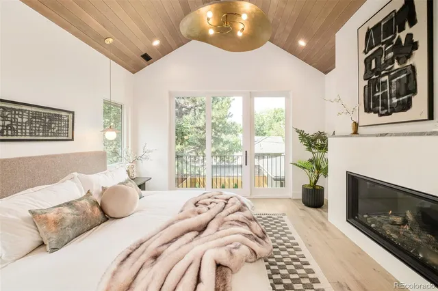 a bedroom with a bed potted plant with a large window