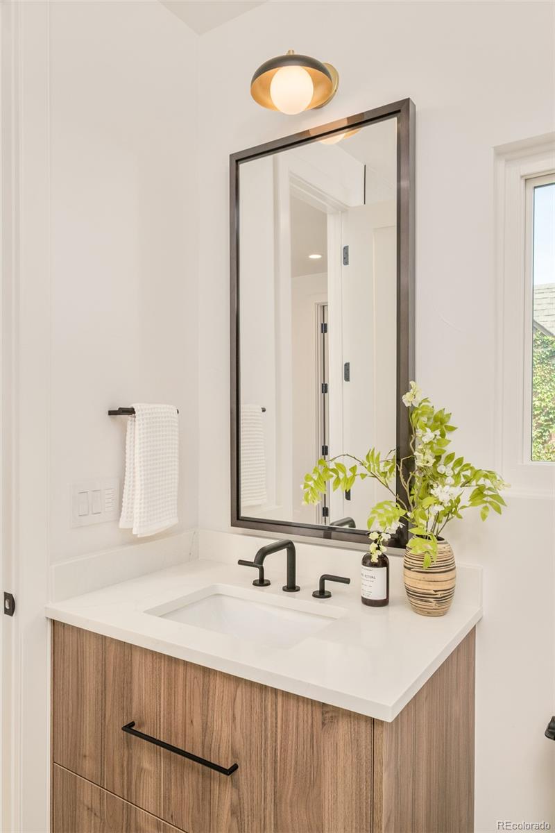 1253 South High Street Denver, CO 80210 - Photo 31 of 46 a bathroom with a sink and a mirror