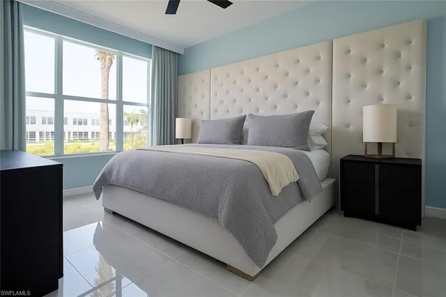 a large bedroom with a bed and a window