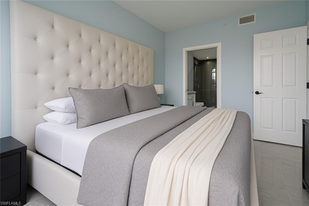 1320 Henley Street, Unit 2003 Naples, FL 34105 - Photo 13 of 36 a bedroom with a bed and a night stand