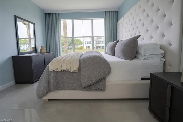 a bed sitting in a bedroom next to a window