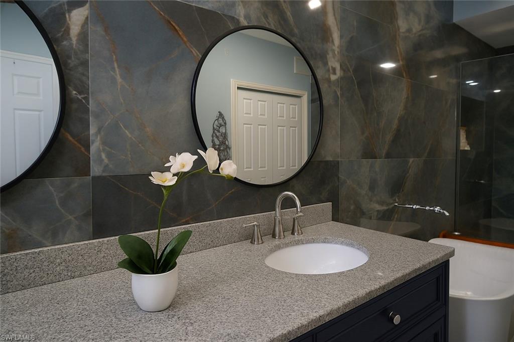 1320 Henley Street, Unit 2003 Naples, FL 34105 - Photo 15 of 36 a bathroom with a sink and a mirror