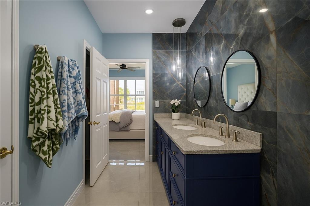 1320 Henley Street, Unit 2003 Naples, FL 34105 - Photo 16 of 36 a en suite bathroom with a double vanity sink and a mirror