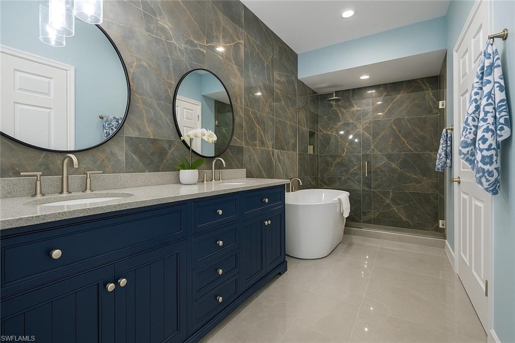 1320 Henley Street, Unit 2003 Naples, FL 34105 - Photo 18 of 36 a bathroom with a double vanity sink and a mirror