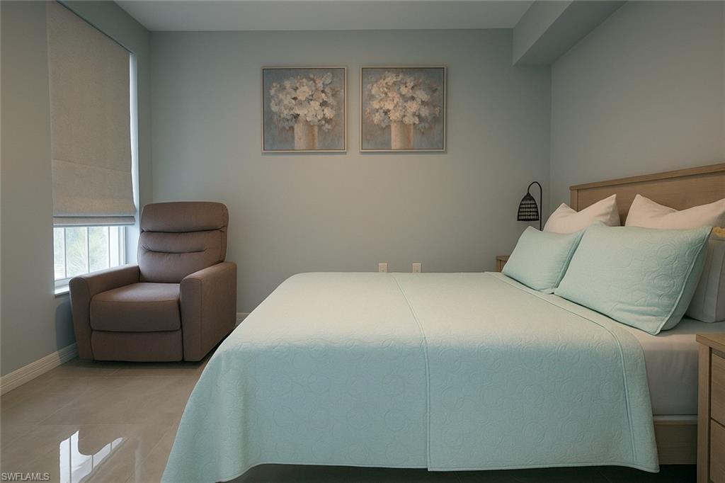 1320 Henley Street, Unit 2003 Naples, FL 34105 - Photo 21 of 36 a bedroom with a bed and chair