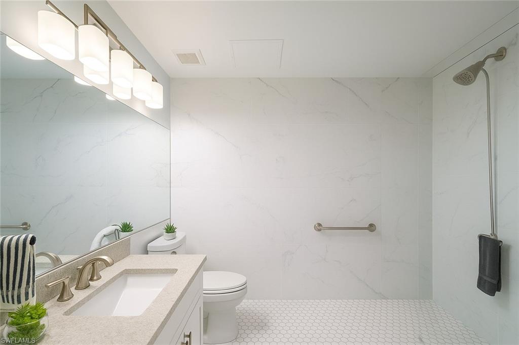 1320 Henley Street, Unit 2003 Naples, FL 34105 - Photo 22 of 36 a bathroom with a sink a toilet and shower