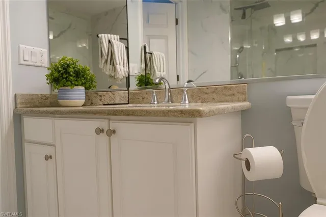 a bathroom with a glass shower door