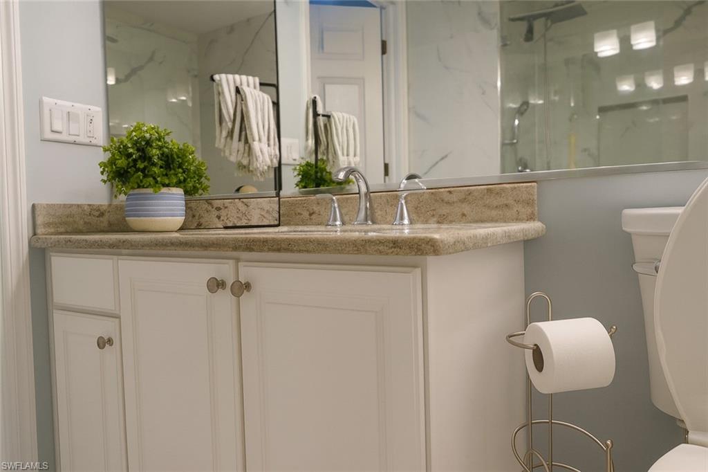 1320 Henley Street, Unit 2003 Naples, FL 34105 - Photo 23 of 36 a bathroom with a granite countertop sink and a mirror