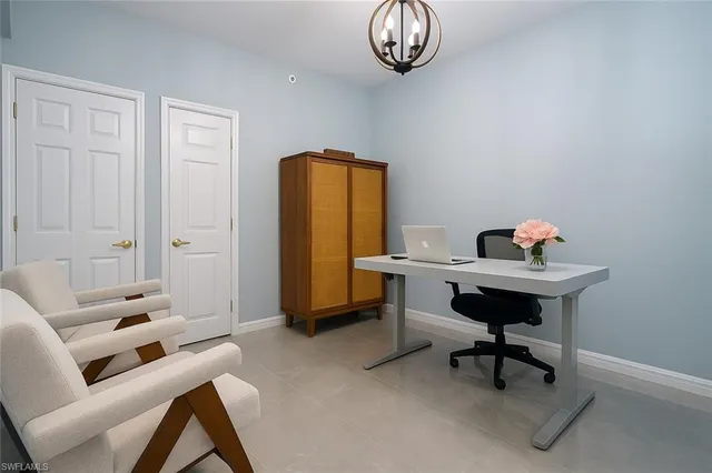 a work room with furniture and a window