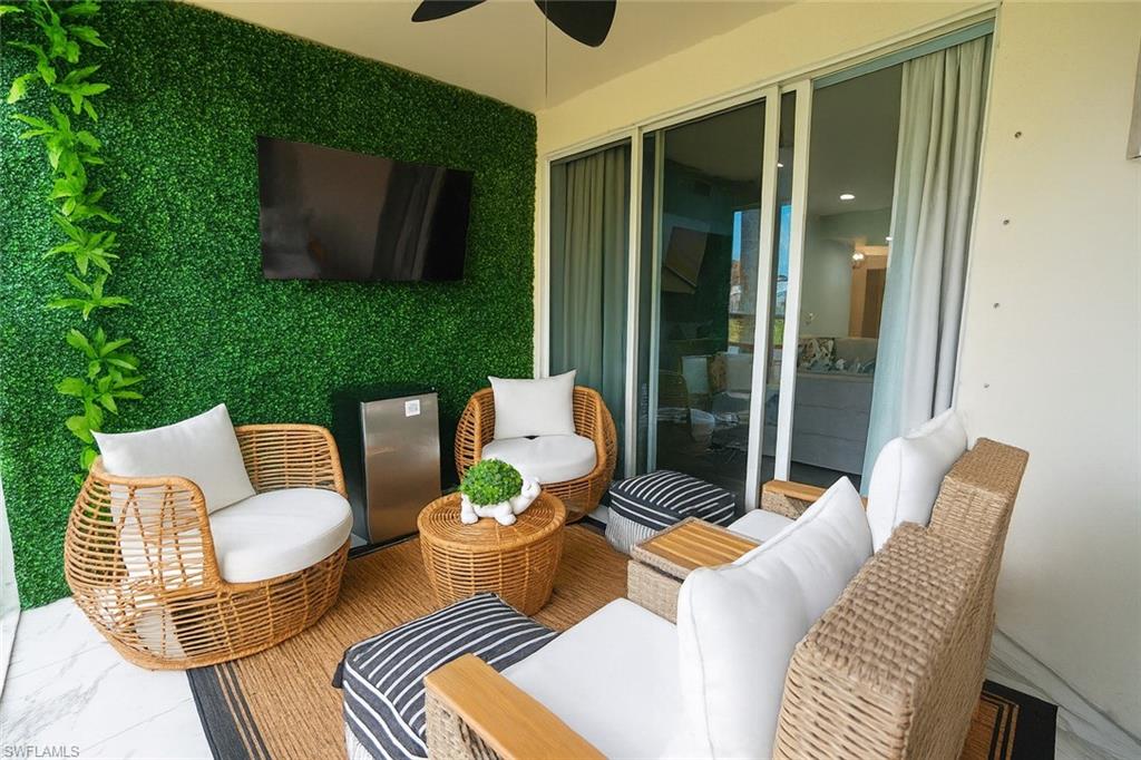 1320 Henley Street, Unit 2003 Naples, FL 34105 - Photo 30 of 36 a outdoor living room with furniture and a flat screen tv