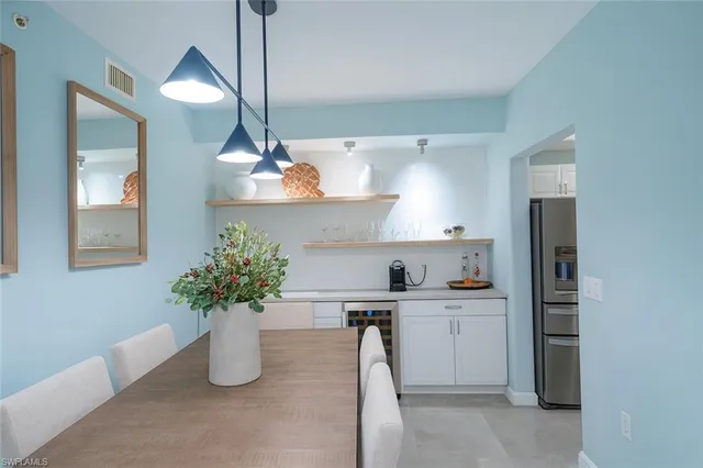 a kitchen with a refrigerator and a sink