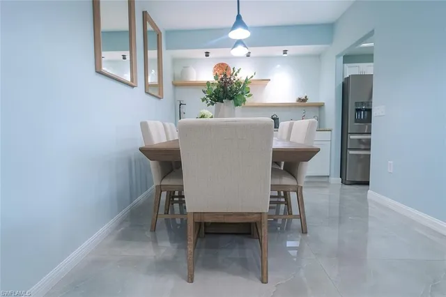 a view of a dining room with furniture and a chandelier