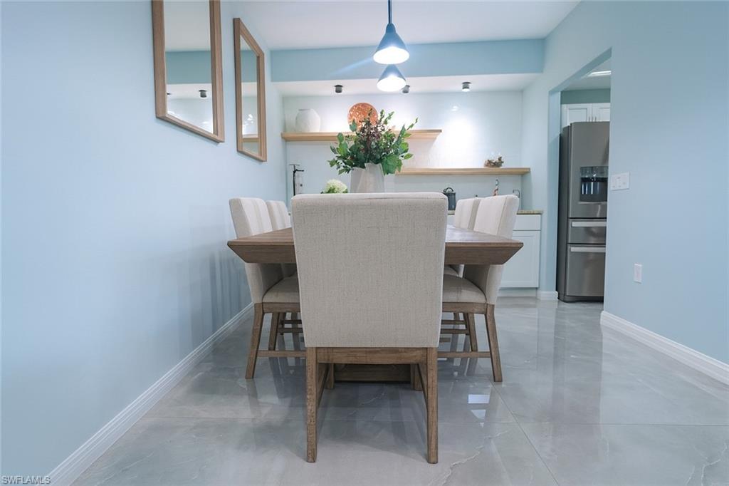 1320 Henley Street, Unit 2003 Naples, FL 34105 - Photo 5 of 36 a view of a dining room with furniture and a chandelier