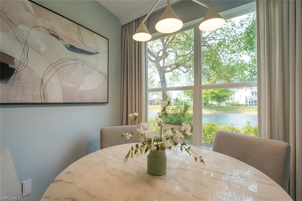 1320 Henley Street, Unit 2003 Naples, FL 34105 - Photo 9 of 36 a view of a dining room with furniture and a window