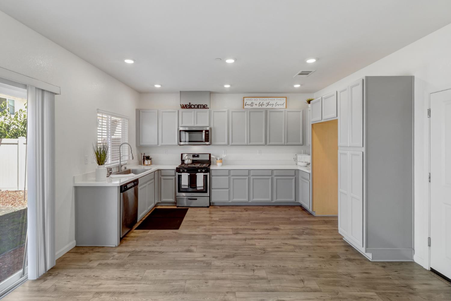 2887 Krone Way Antelope, CA 95843 - Photo 6 of 46 a kitchen with stainless steel appliances a refrigerator and a stove top oven