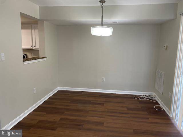 13901 King Gregory Way, Unit 391 Upper Marlboro, MD 20772 - Photo 9 of 14 a view of an empty room with wooden floor