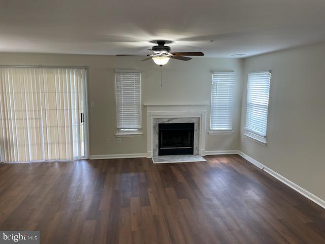 13901 King Gregory Way, Unit 391 Upper Marlboro, MD 20772 - Photo 10 of 14 an empty room with wooden floor fireplace and windows