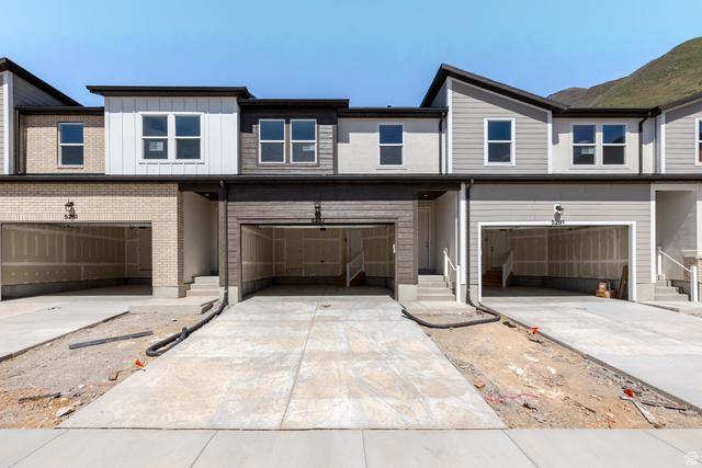 5287 South Acacia Drive, Unit 714 Mapleton, UT 84664 - Photo 2 of 21 Contemporary townhome exterior featuring a combination of brick, horizontal siding, and vertical paneling
