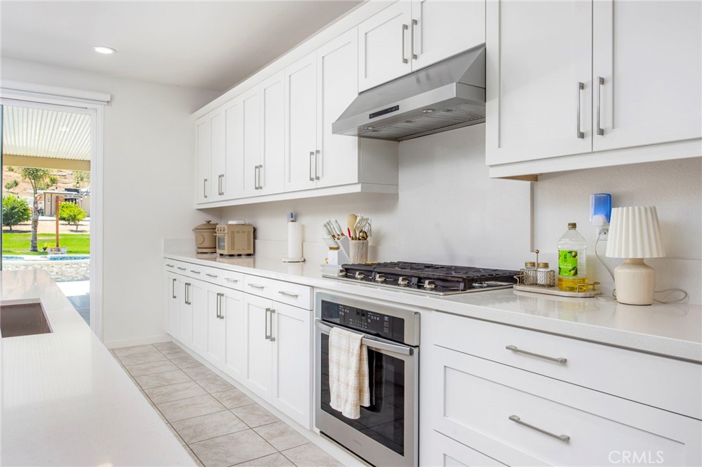 32797 Hayden Road Menifee, CA 92584 - Photo 17 of 51 a kitchen with stainless steel appliances granite countertop a sink and a stove