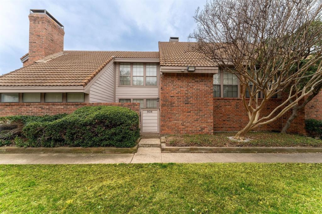 18240 Midway Road, Unit 904 Dallas, TX 75287 - Photo 1 of 1 a front view of a house with a yard
