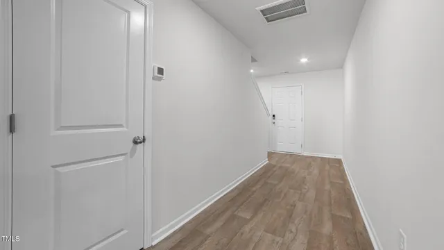 a view of hallway with wooden floor