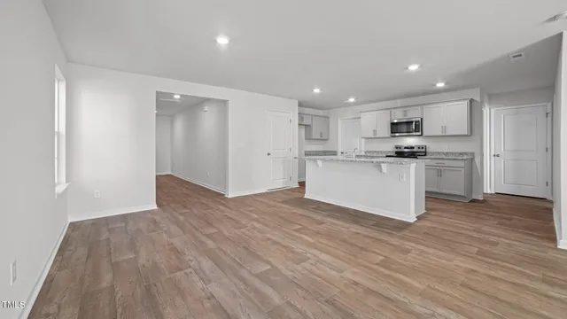 a view of kitchen with wooden floor and electronic appliances