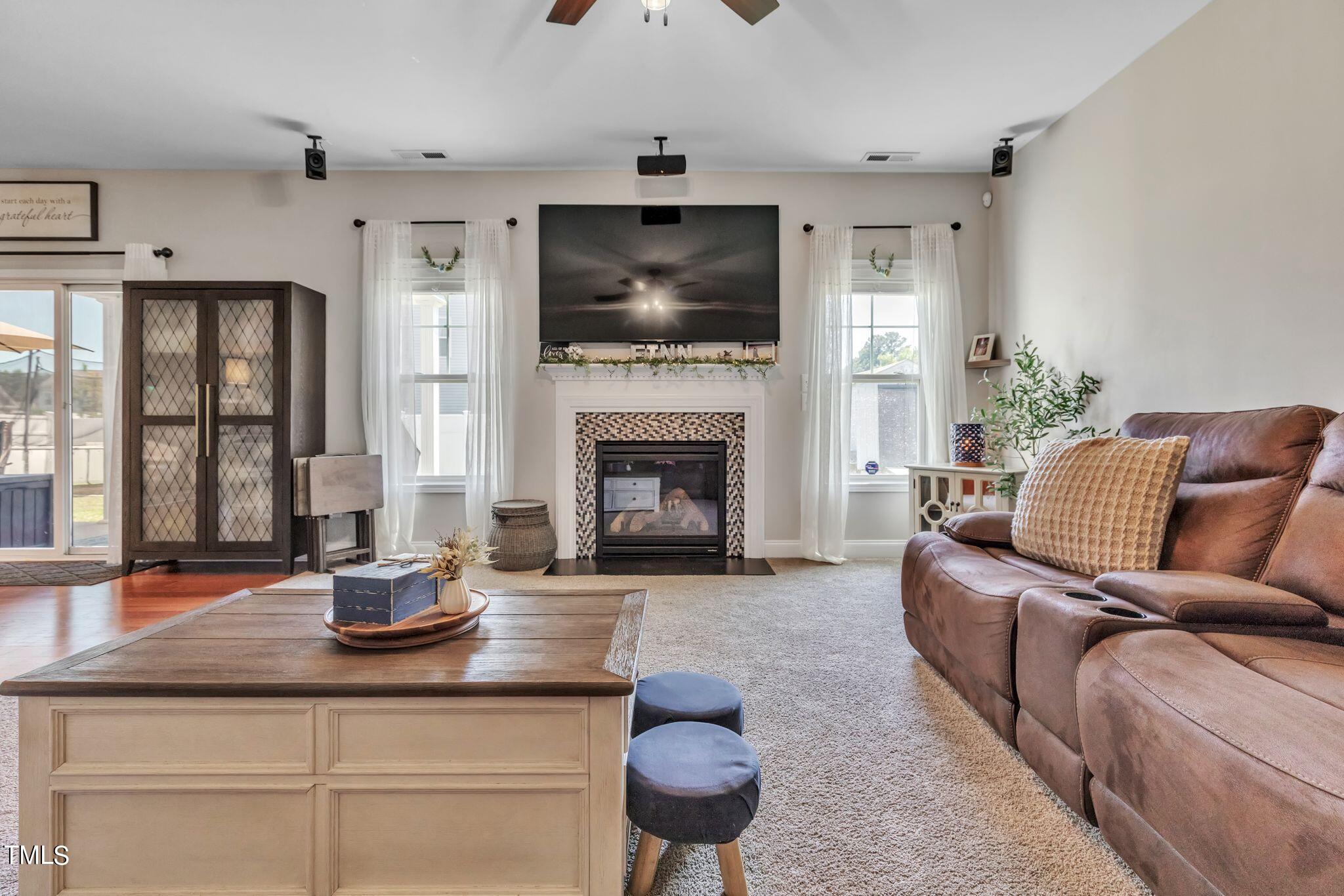 111 Oldstead Drive Raeford, NC 28376 - Photo 13 of 28 a living room with furniture a flat screen tv and a fireplace