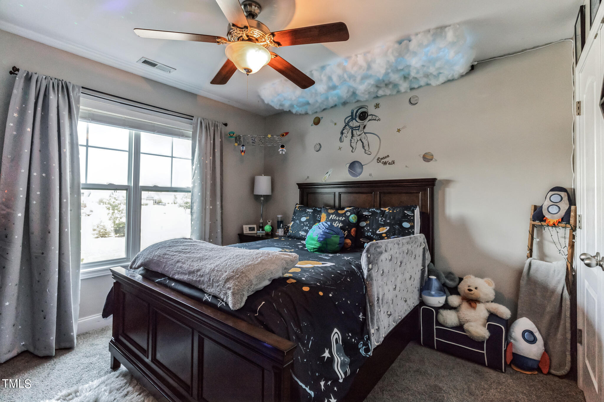 111 Oldstead Drive Raeford, NC 28376 - Photo 25 of 28 a bedroom with a bed and a chandelier