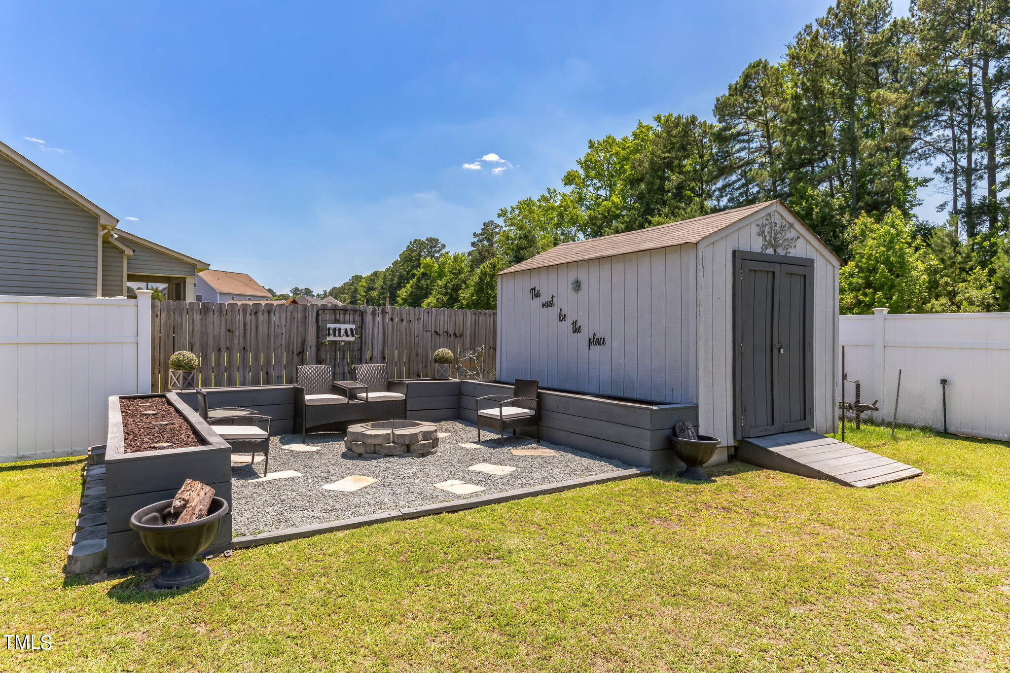111 Oldstead Drive Raeford, NC 28376 - Photo 4 of 28 a view of a backyard with a sink and wooden fence