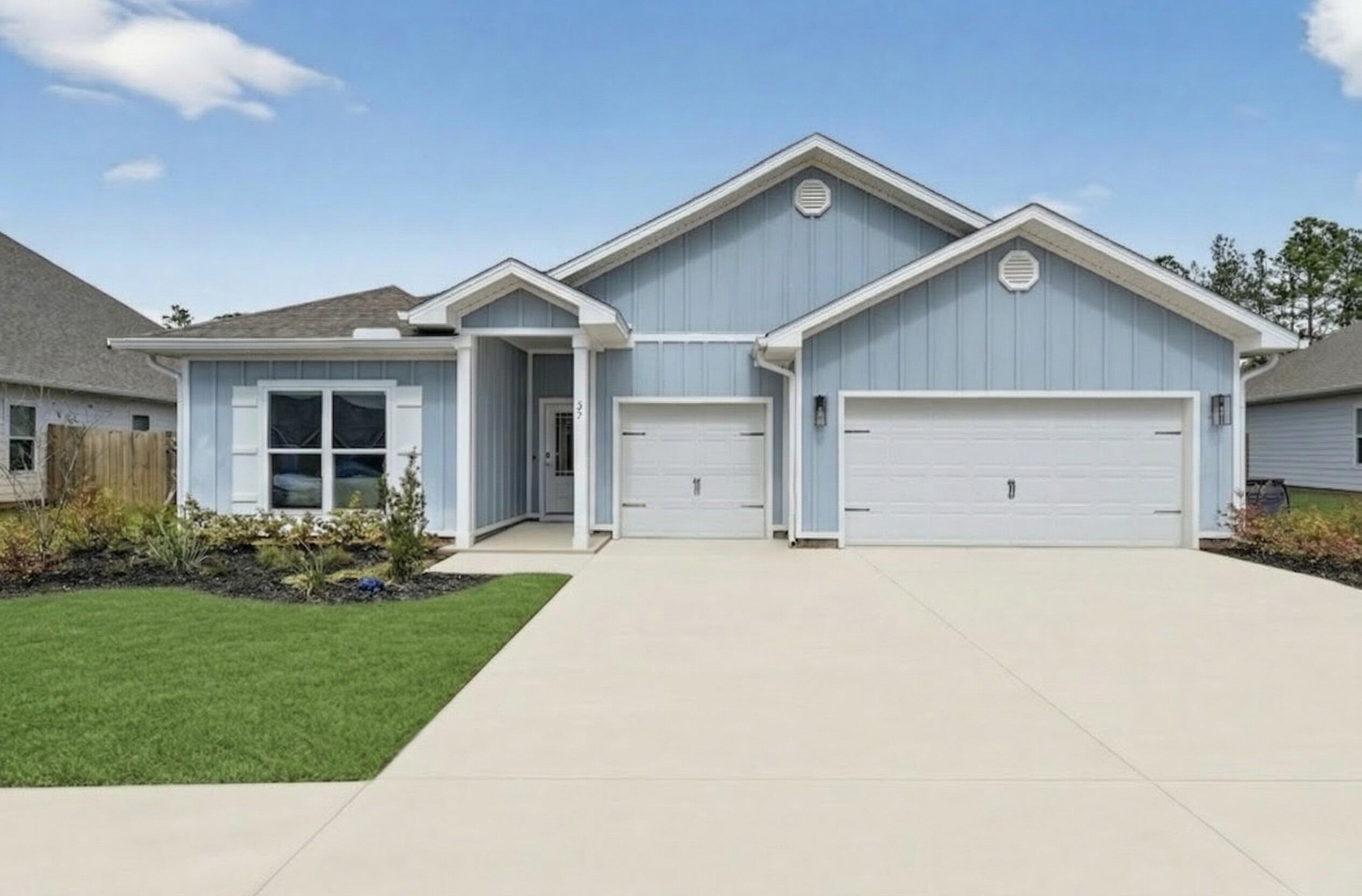 27 Oak Trees Lane East Freeport, FL 32439 - Photo 2 of 33 a front view of a house with a yard and garage