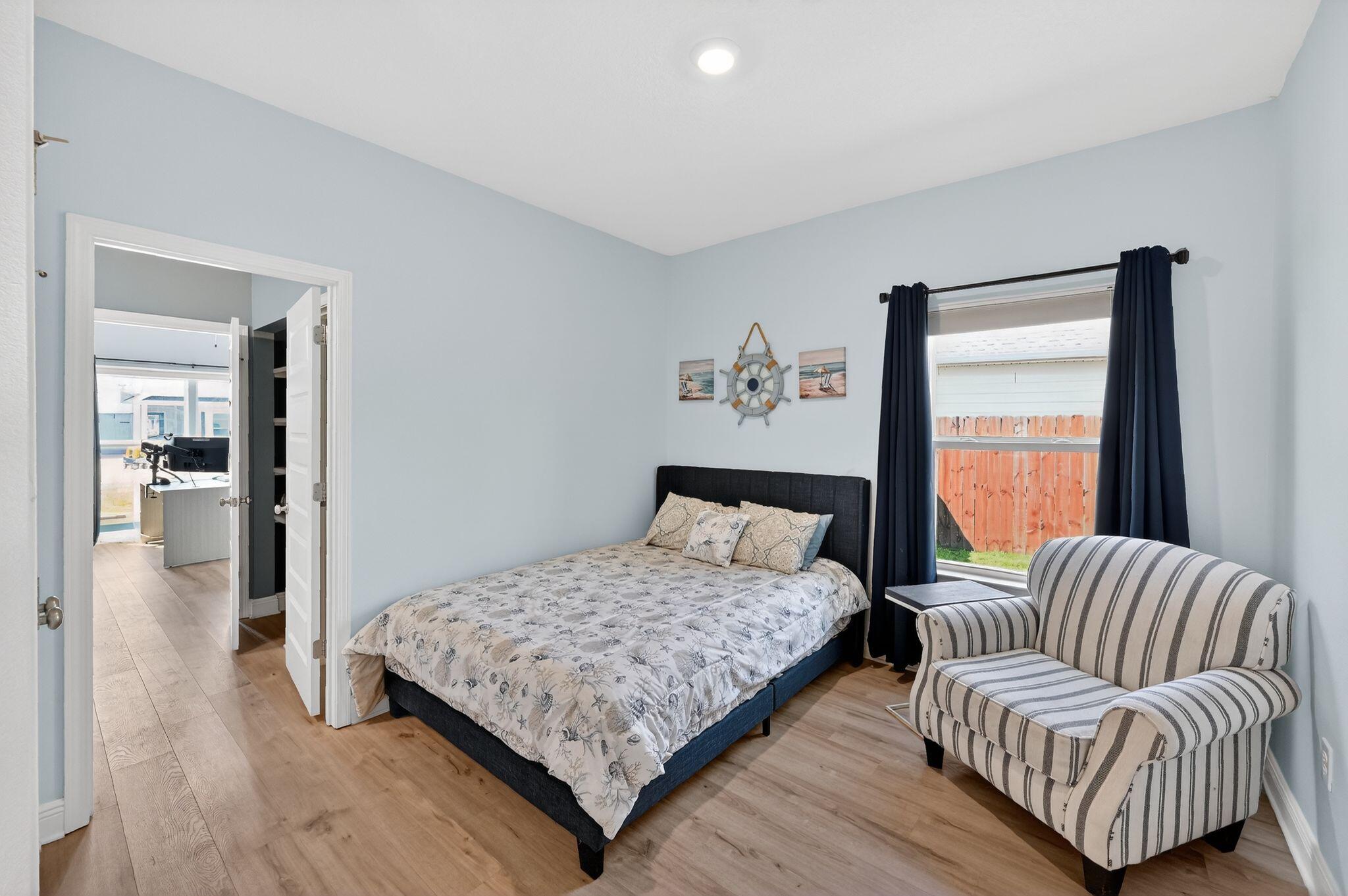 27 Oak Trees Lane East Freeport, FL 32439 - Photo 21 of 33 a bedroom with a bed and glass walk in closet