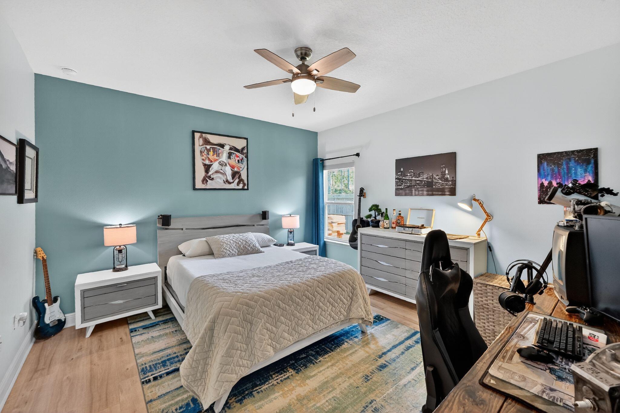 27 Oak Trees Lane East Freeport, FL 32439 - Photo 24 of 33 a bedroom with a bed and a flat screen tv