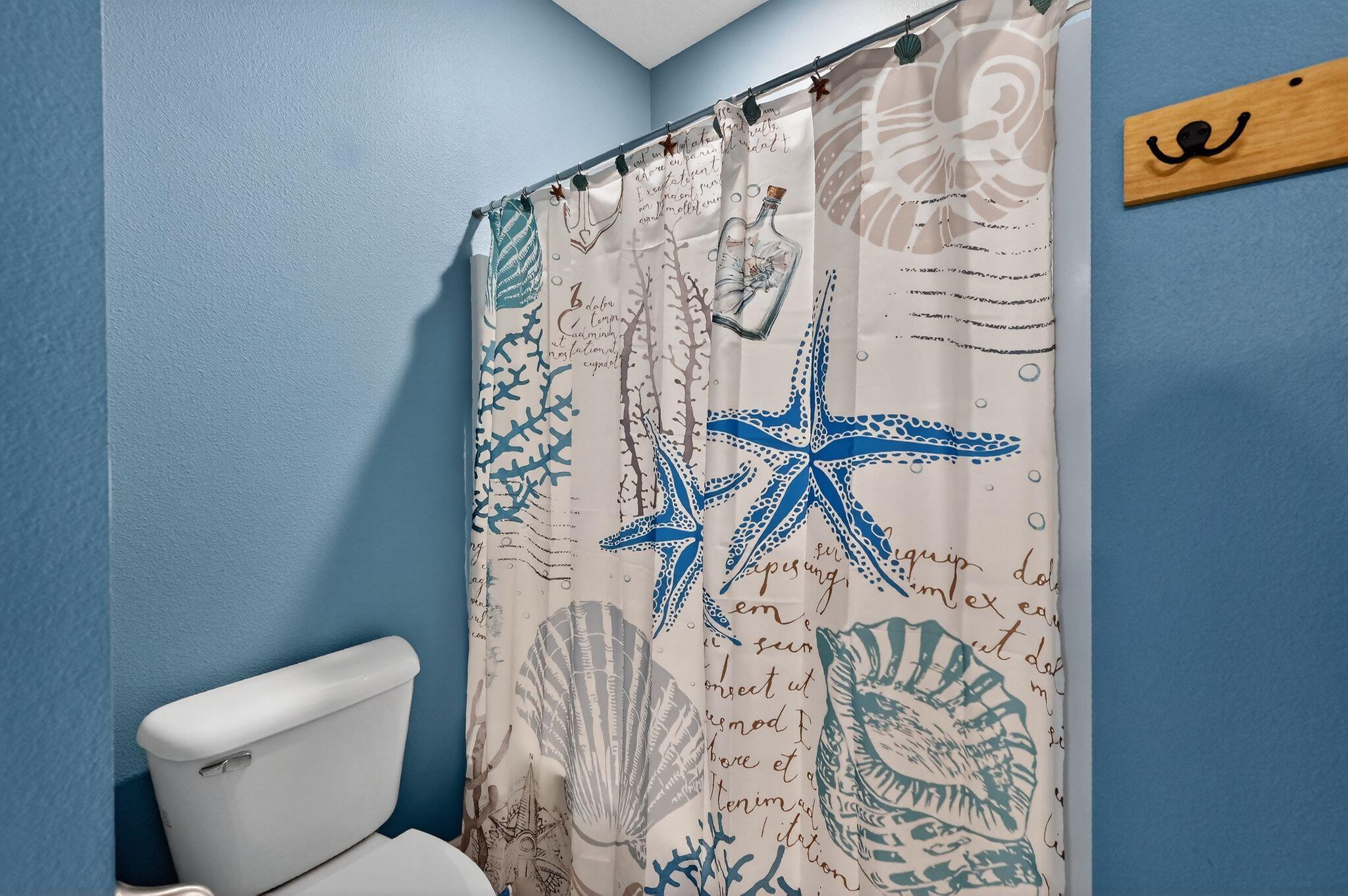 27 Oak Trees Lane East Freeport, FL 32439 - Photo 28 of 33 a white toilet sitting next to a shower curtain