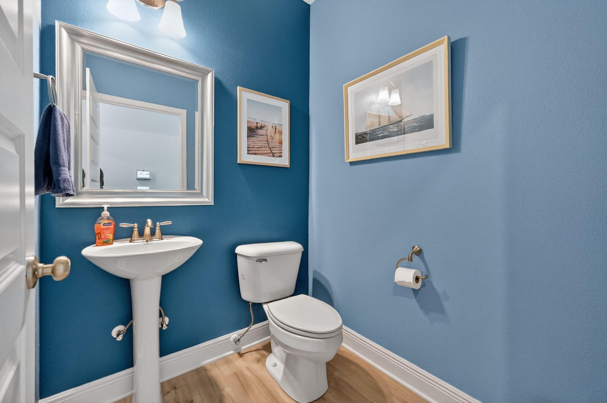 27 Oak Trees Lane East Freeport, FL 32439 - Photo 29 of 33 a bathroom with a toilet a sink and mirror