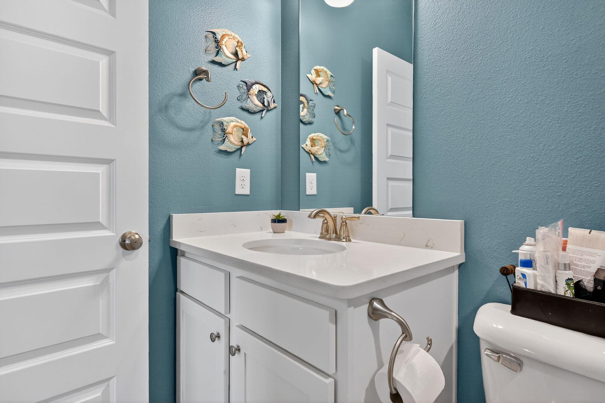 27 Oak Trees Lane East Freeport, FL 32439 - Photo 30 of 33 a bathroom with a sink a toilet and a mirror