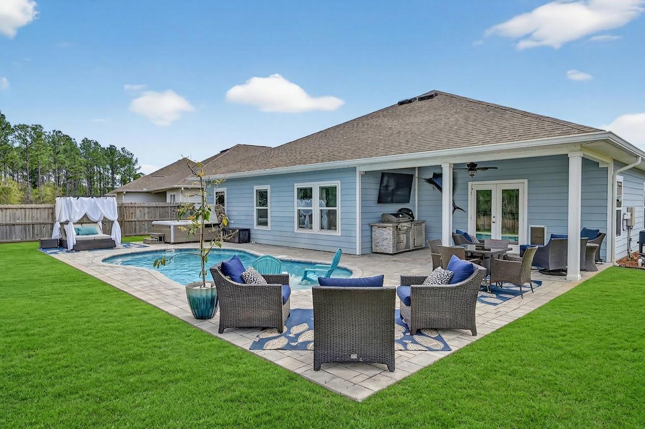 27 Oak Trees Lane East Freeport, FL 32439 - Photo 3 of 33 a view of a house with backyard sitting area and garden