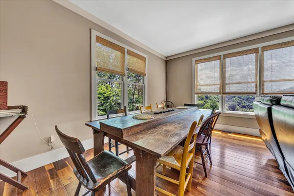 a view of a dining room with furniture window and wooden floor