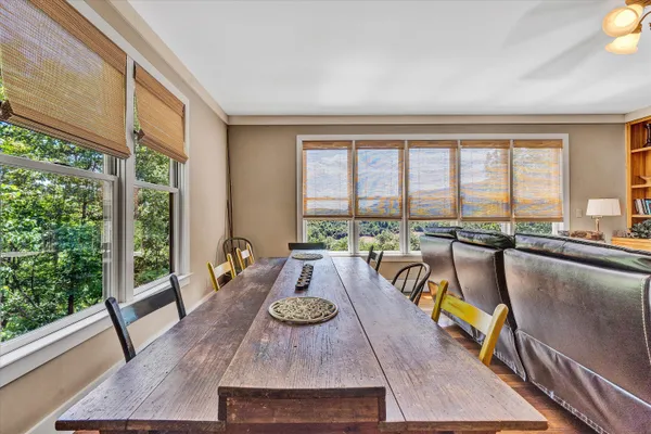 a living room with furniture and floor to ceiling windows