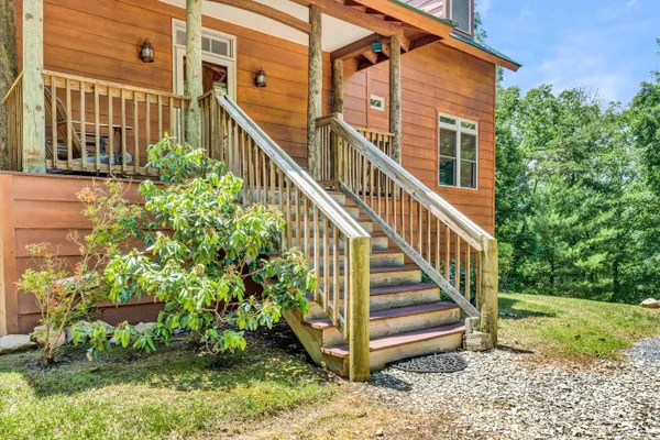 a view of a house with backyard and deck