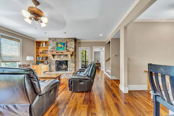 a living room with furniture a fireplace and a flat screen tv