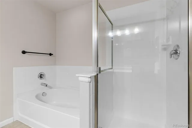 an empty room with windows and ceiling fan