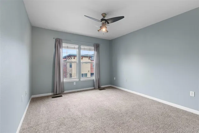 a bedroom with bed couches and a potted plant