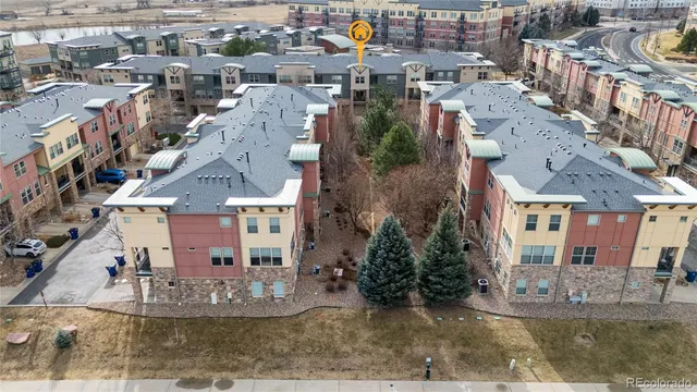 an aerial view of a house with a yard and lake view