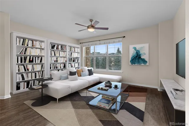 a living room with furniture a rug and a flat screen tv