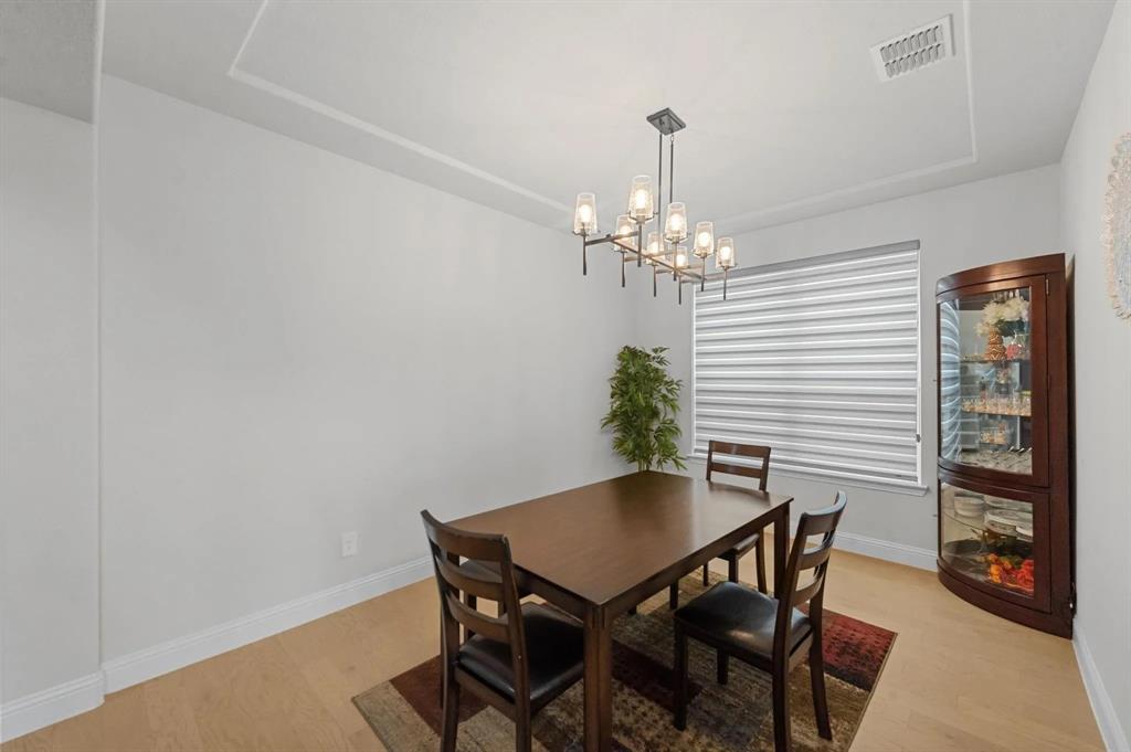10969 Coastal Violet Road Frisco, TX 75035 - Photo 10 of 30 Dining area with light wood-type flooring and a chandelier