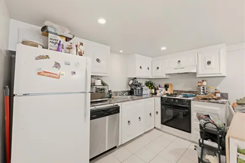 a white kitchen with cabinets and white appliances
