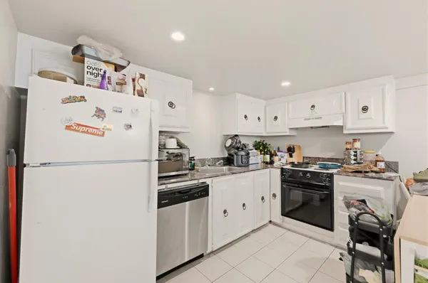 a white kitchen with cabinets and white appliances