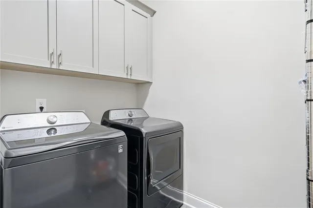 a living room with furniture a flat screen tv and a large window